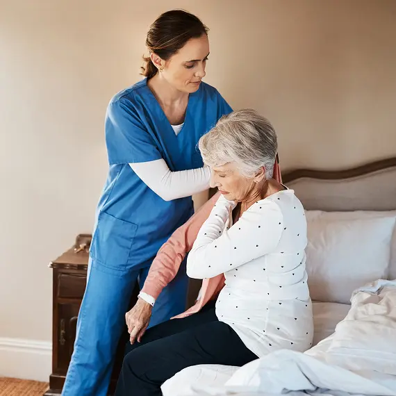Caretaker helping an elderly patient